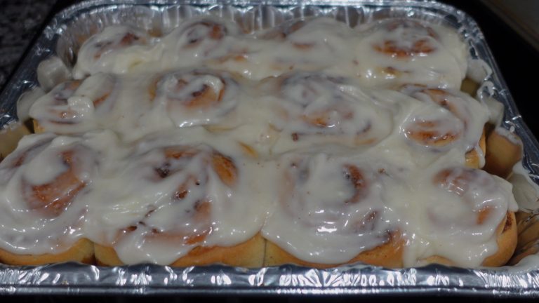 Pan of cinnamon rolls with white cream cheese icing