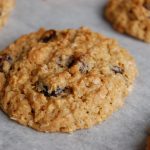 brown cookie with bits of raisins on white paper