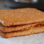 3 brown crackers on white paper