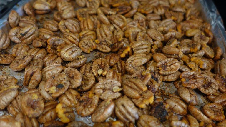 brown and toasty pecans on a pan