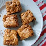 Brown squares of blondies on white plate