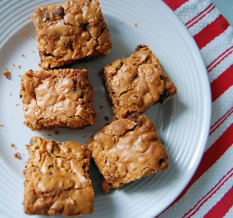Brown squares of blondies on white plate