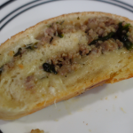 bread rolled with sausage, spinach, and cheese in the middle