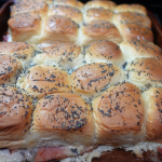 Brown rolls with black poppy seeds on top, ham and cheese in the middle