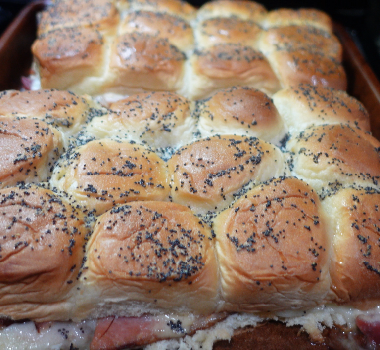 Brown rolls with black poppy seeds on top, ham and cheese in the middle