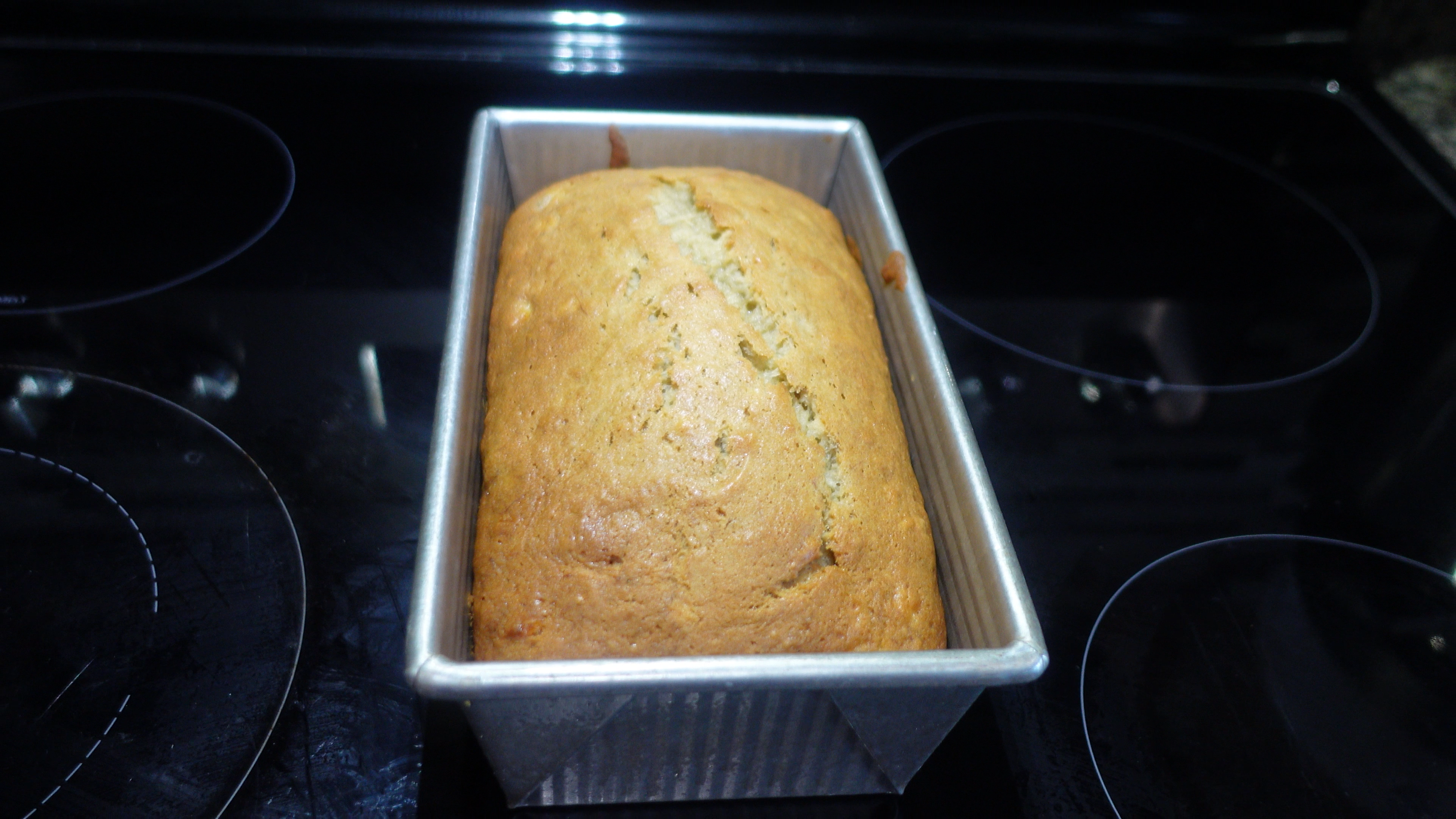 brown bread in gray metal pan